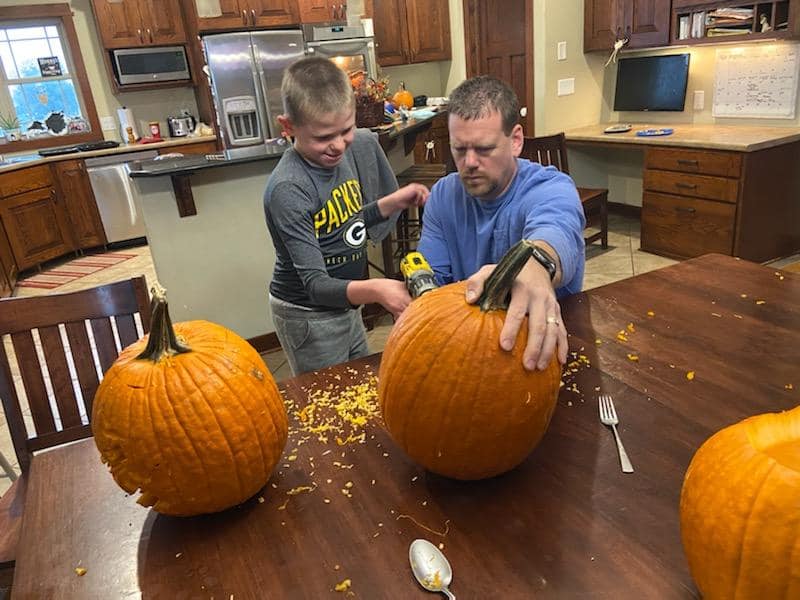 Karl and son carving pumpkins 